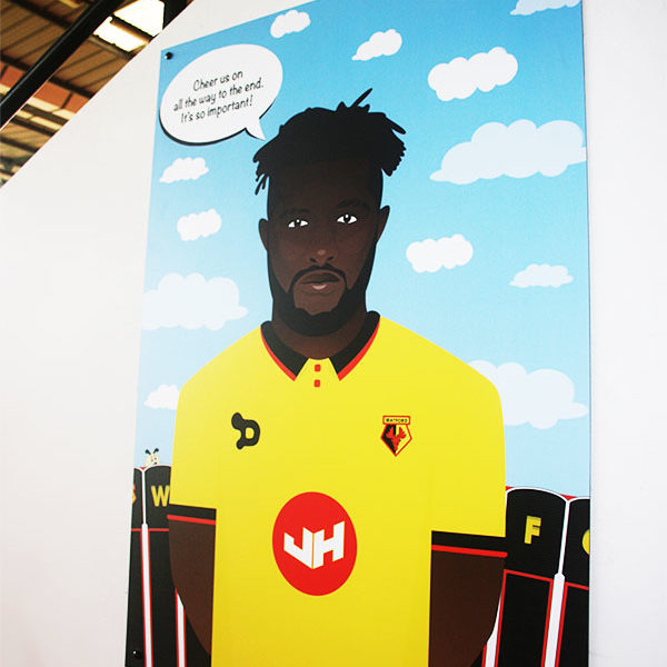Illustration print of Isaac Success, displayed in the Family Stand at Vicarage Road Stadium.